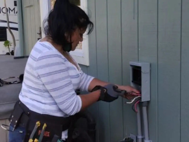 Licensed electrician wiring an exterior subpanel in Malmstrom AFB
