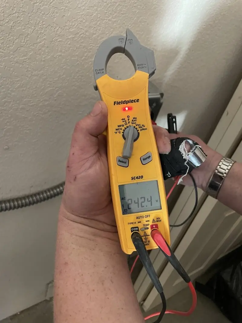 Voltage testing with clamp meter during Whole House Surge Protector in Malmstrom AFB